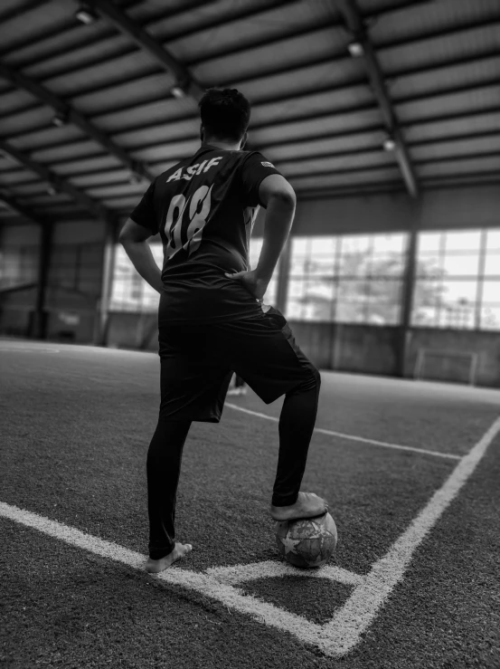 a soccer player prepares to kick the ball