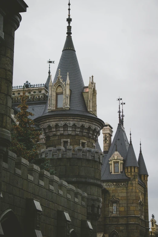 a tall stone building with a cross on it