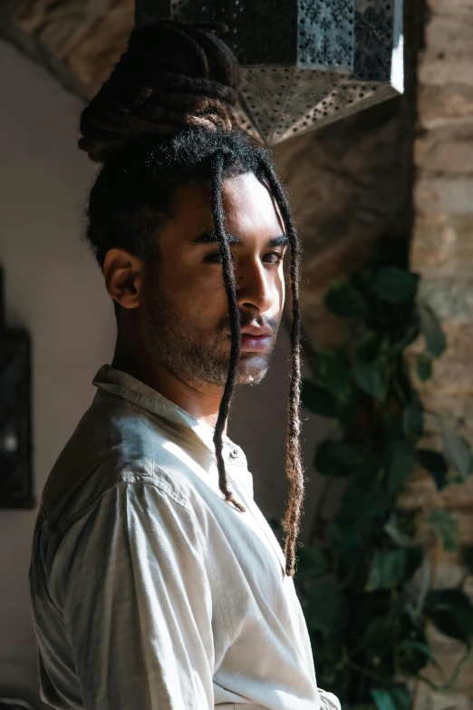 a man with dreadlocks sitting down