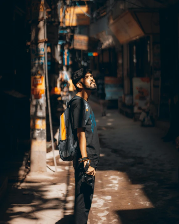 a man walking down an alley with his back pack