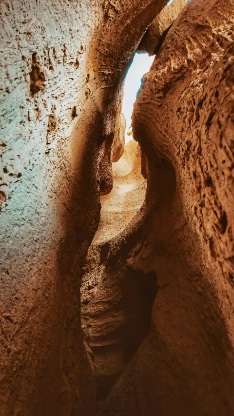 a trail through an eroded canyon with blue sky