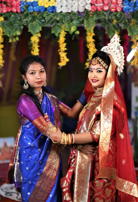 a beautiful young lady standing next to an older woman