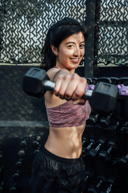 a young woman is training in the gym