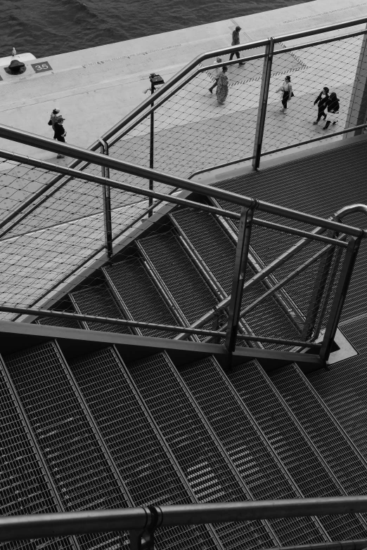 a group of people walking up and down some stairs