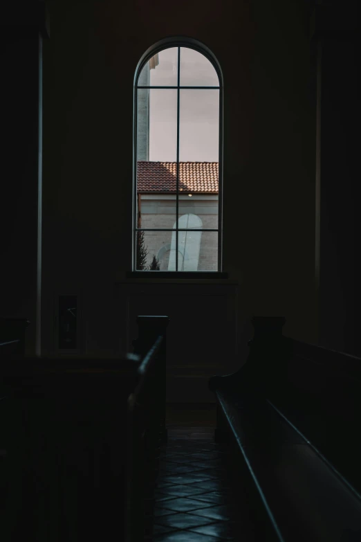 an open window to an old house with dark lighting