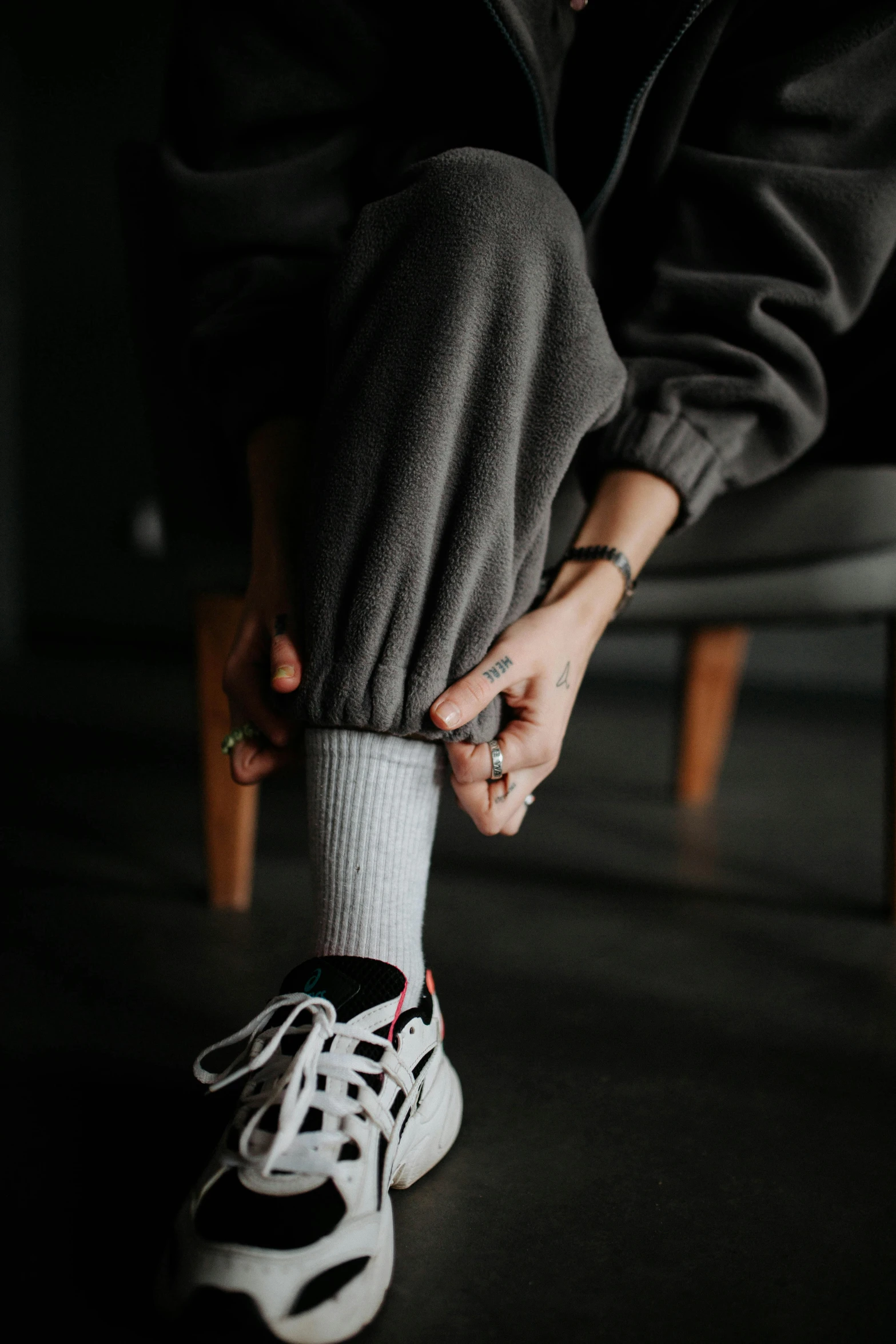 person tying a black and white nike sneakers