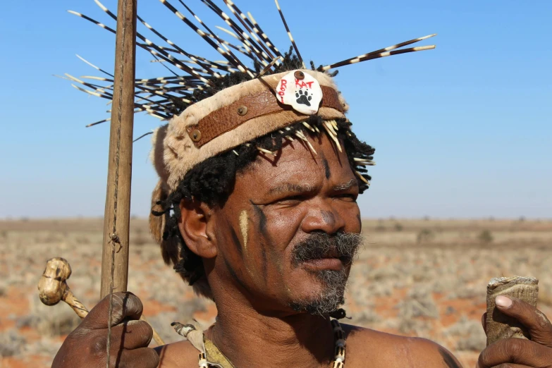 the man is standing outside with his head dress on