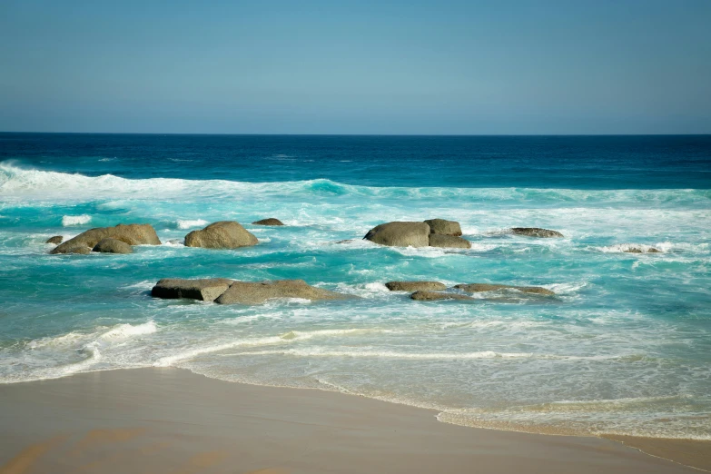 many large rocks sitting in the water