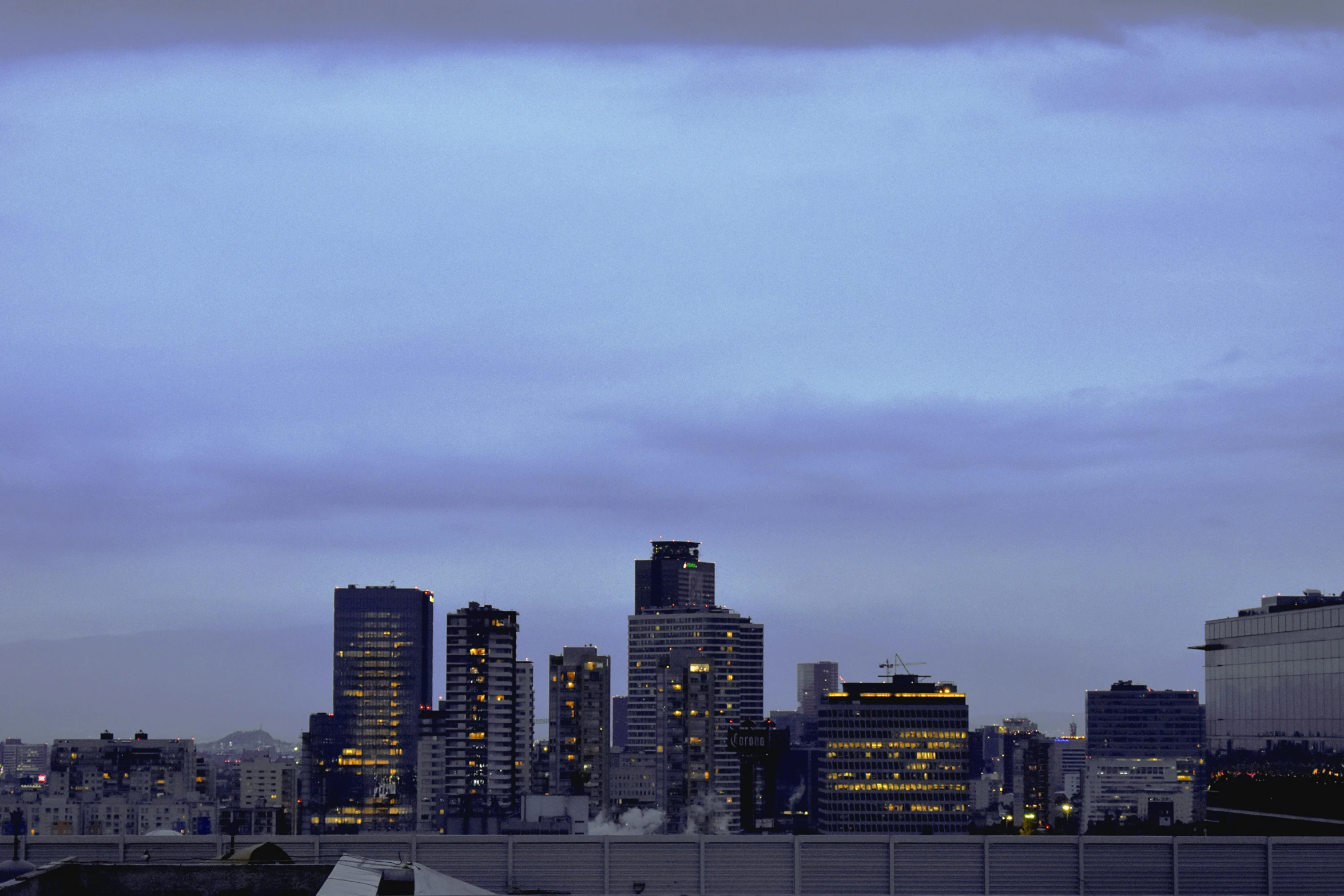 an airplane with lights on flying over a city