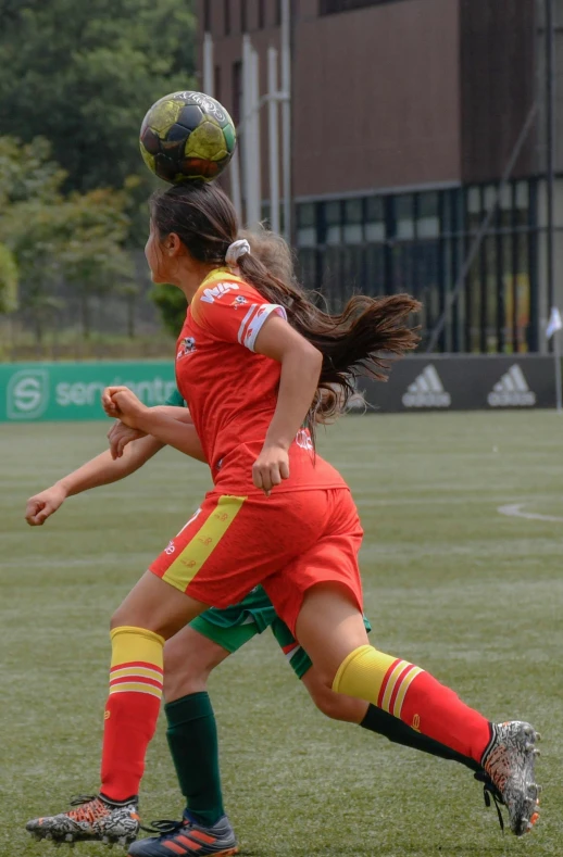 girls play soccer in the middle of a game