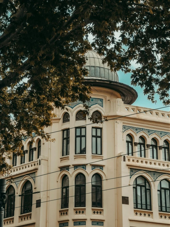 a beige building with large windows on top of it