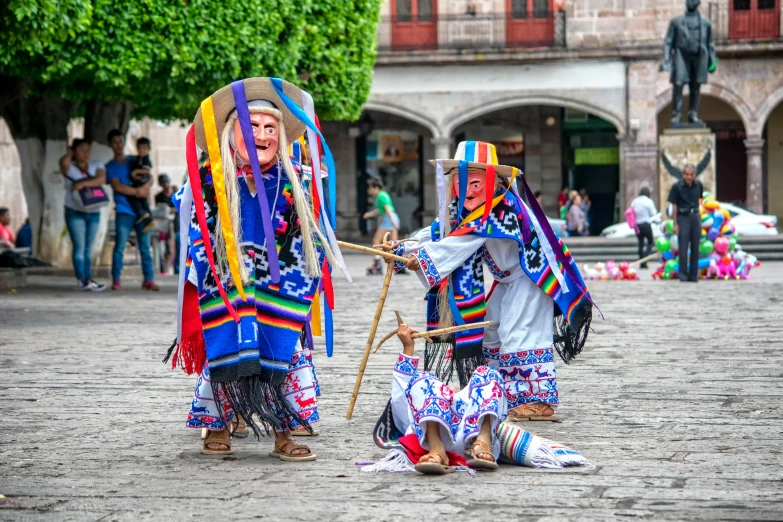 two people are performing soing with a pole in front of them