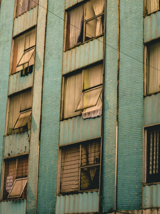 this is an image of blue building with some curtains