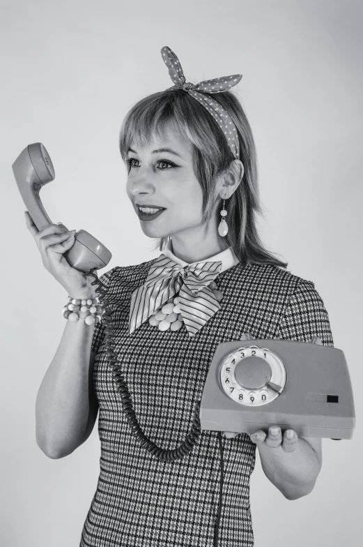 woman holding a phone up to a very weird phone