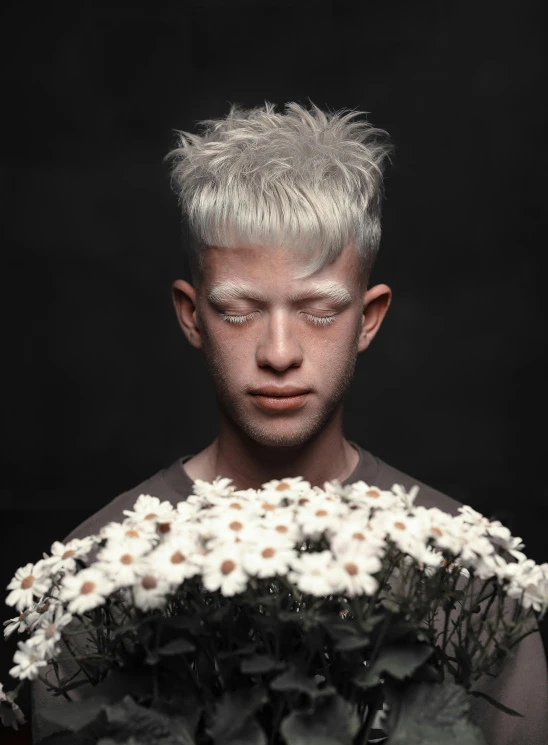 a person with white makeup, and flowers in his hands