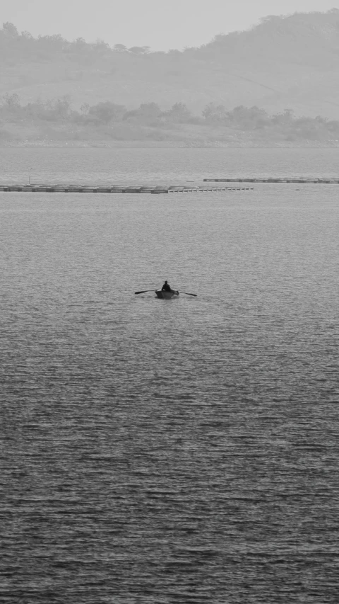 two people in the ocean near mountains