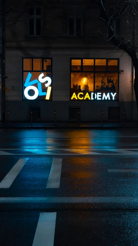 a rainy street in front of a store lit by a neon sign