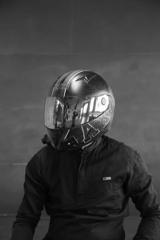 man wearing a helmet and a jacket looking at soing