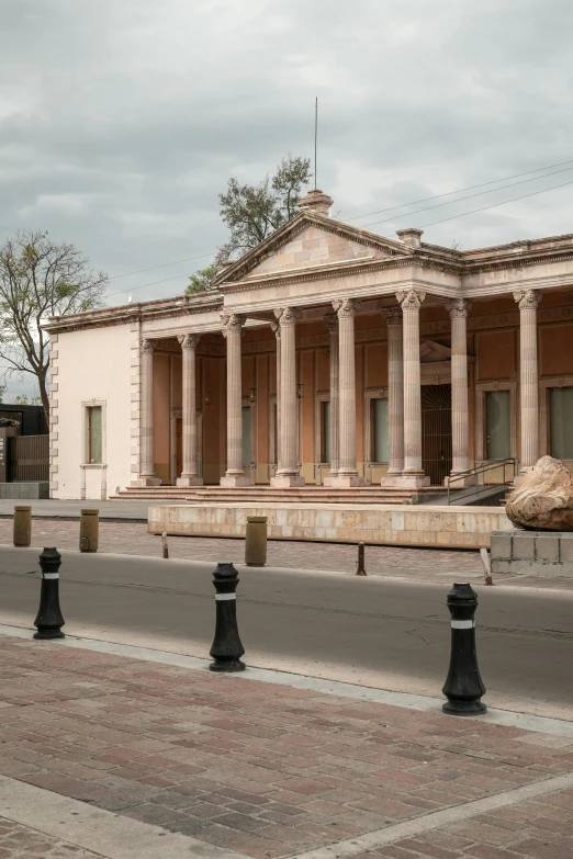 a small old building with pillars on top