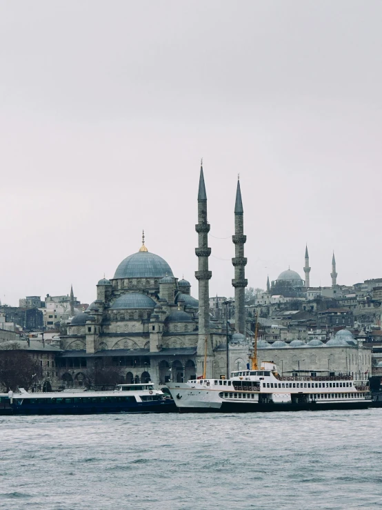 a ship in the water in front of some buildings