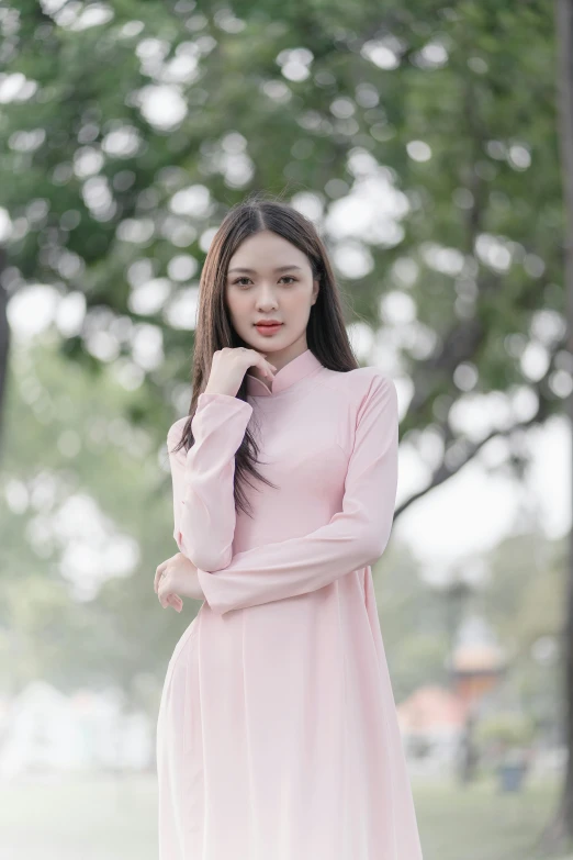 a very attractive woman posing for a po in a dress