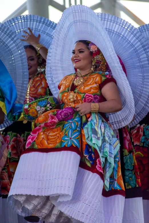 people in mexican costumes at an outdoor event