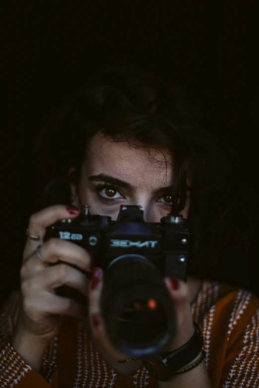 a woman is taking pictures of herself using a camera