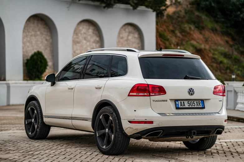 the white vw touara parked in front of a house