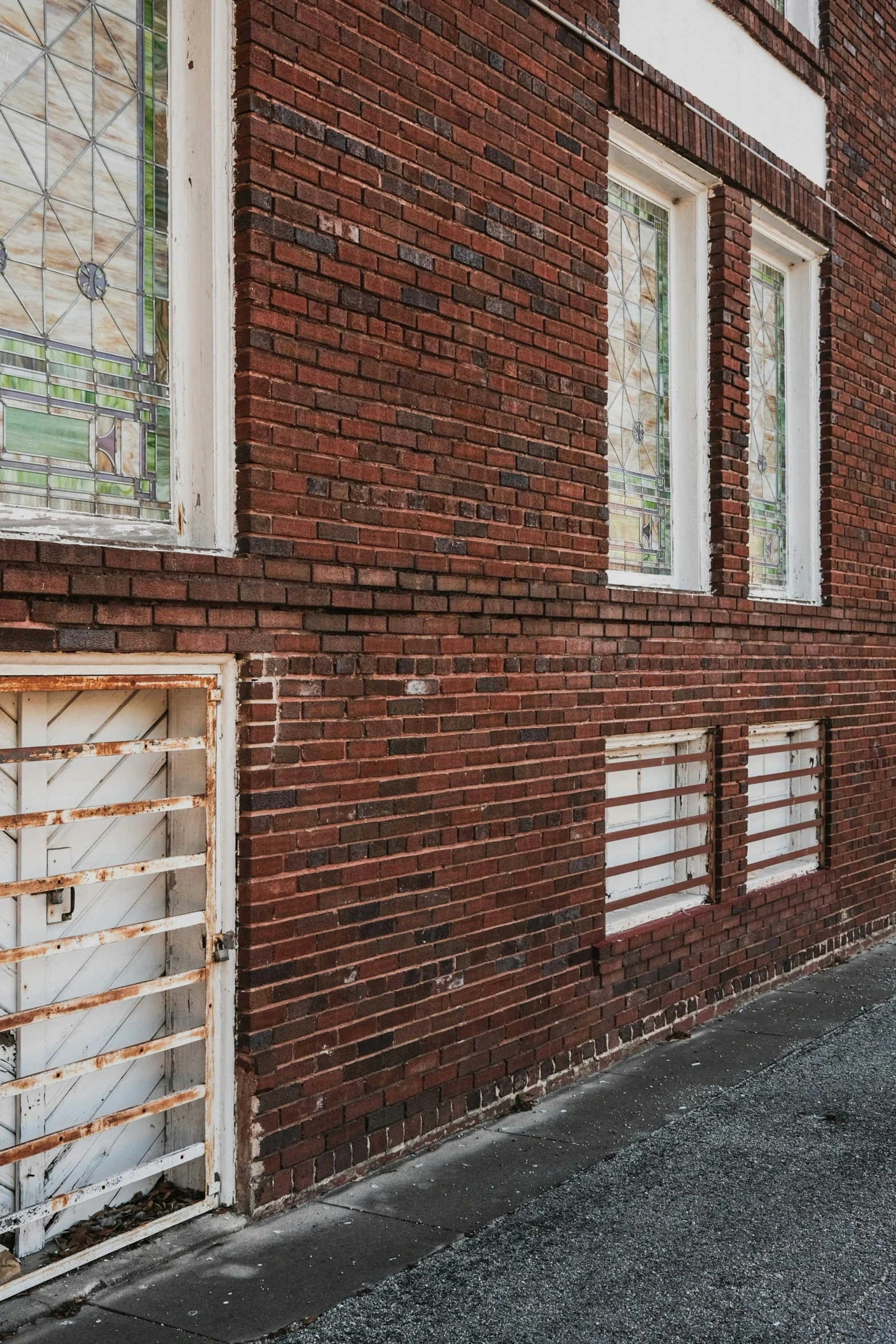 a fire hydrant is located near the side of a brick building