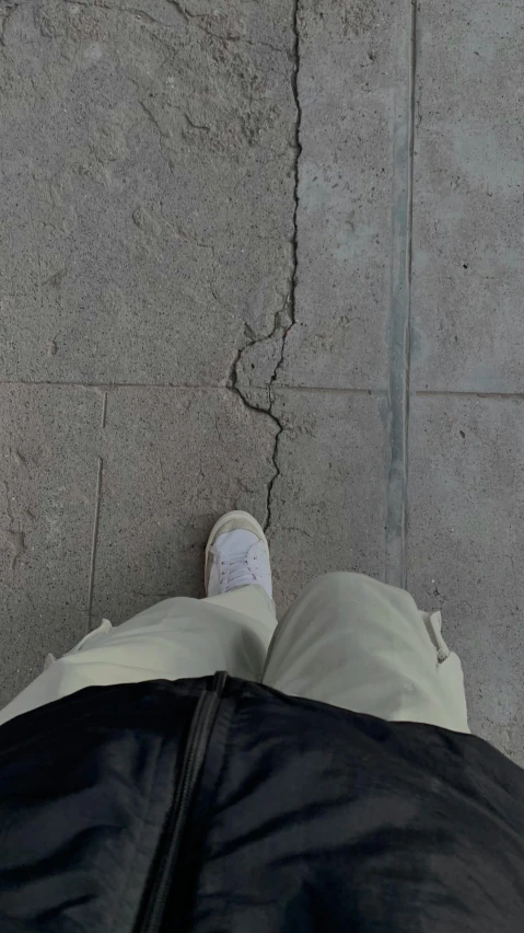 a persons feet sticking their head in the concrete