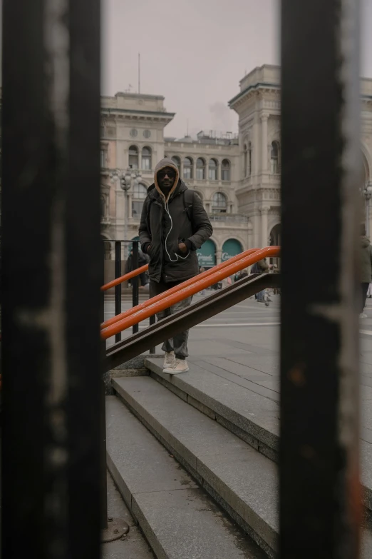 a young man walking up some stairs on an overcast day