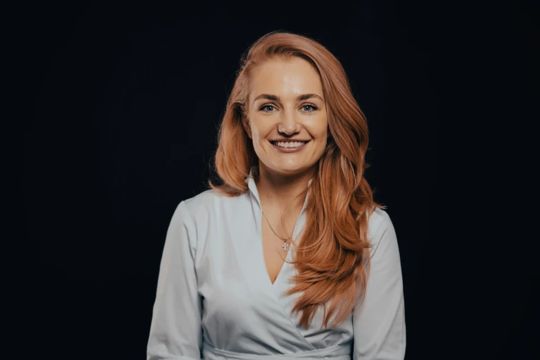 a beautiful young woman with red hair wearing a white dress