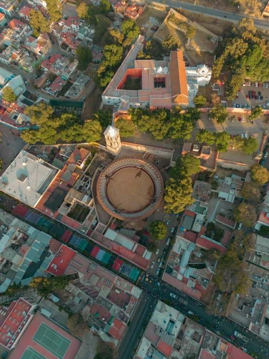 a city has an old clock tower and is surrounded by red brick