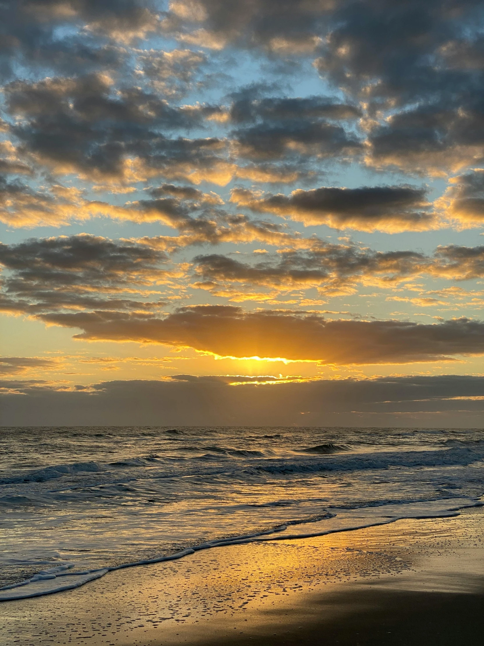 a bright sun in the sky over a beach