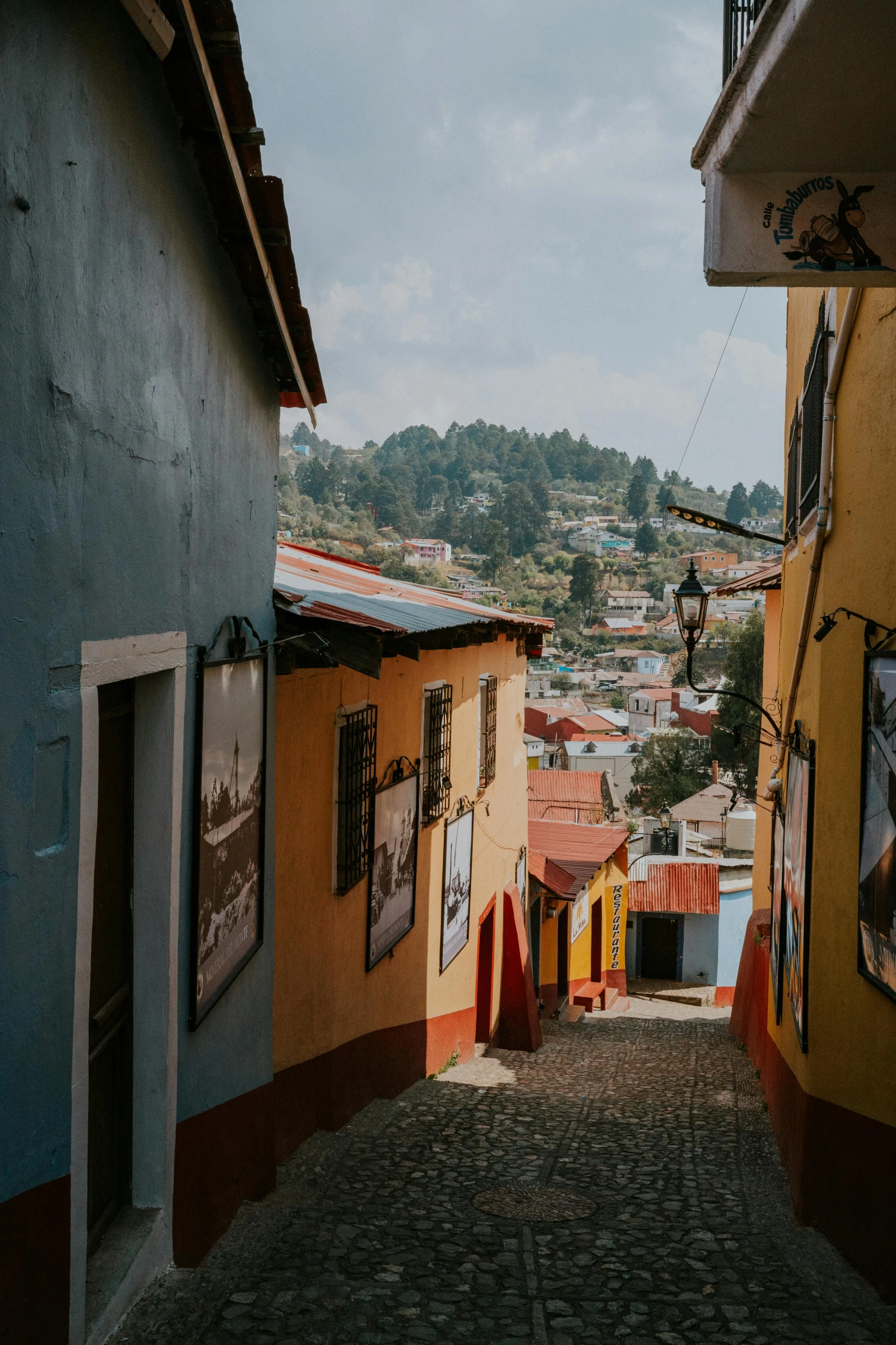 a city is seen through a narrow street