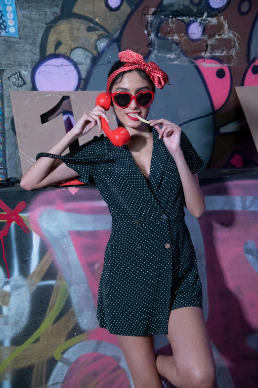 a woman in sunglasses is posing with a bag