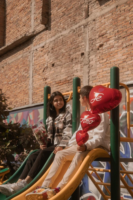 a woman and a child ride on a play set