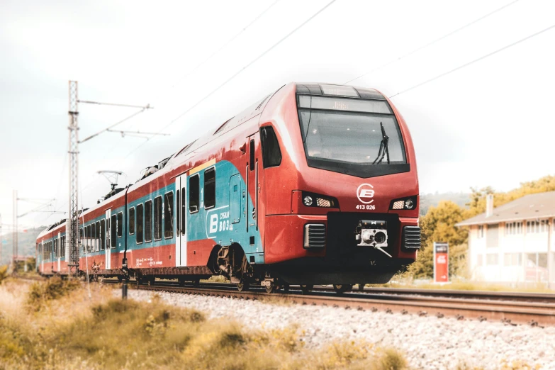 a train traveling on the train tracks near a field