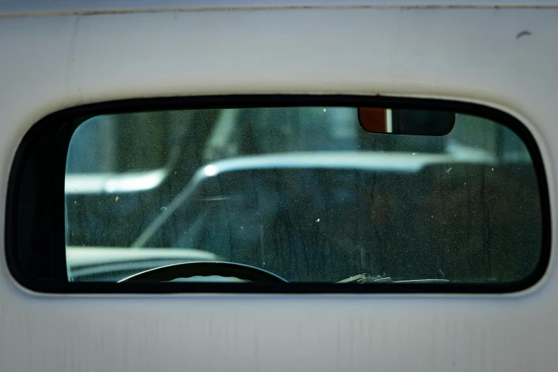 reflection of a white van in the side mirror