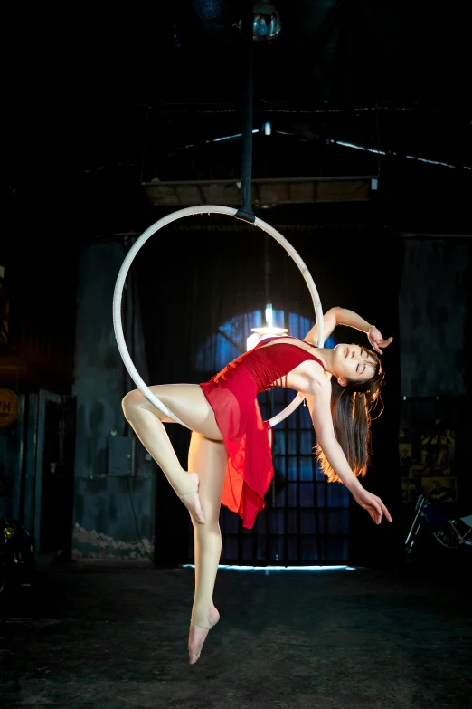 a girl doing tricks with a hula hoop