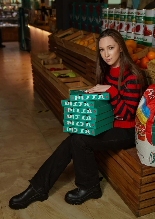 a person sits on a bench with a stack of food