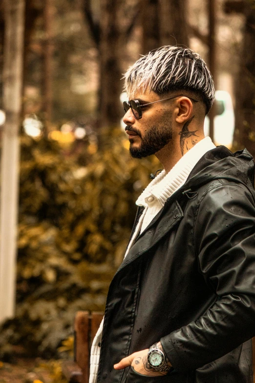 a man with short hair wearing a black leather jacket