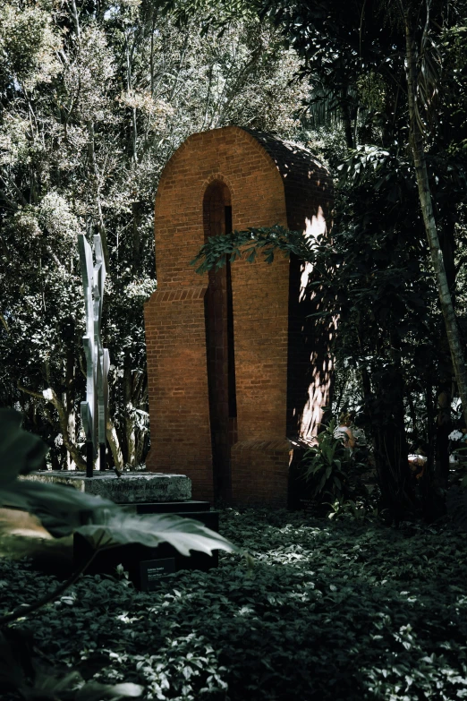 a red building in a forest with trees surrounding it