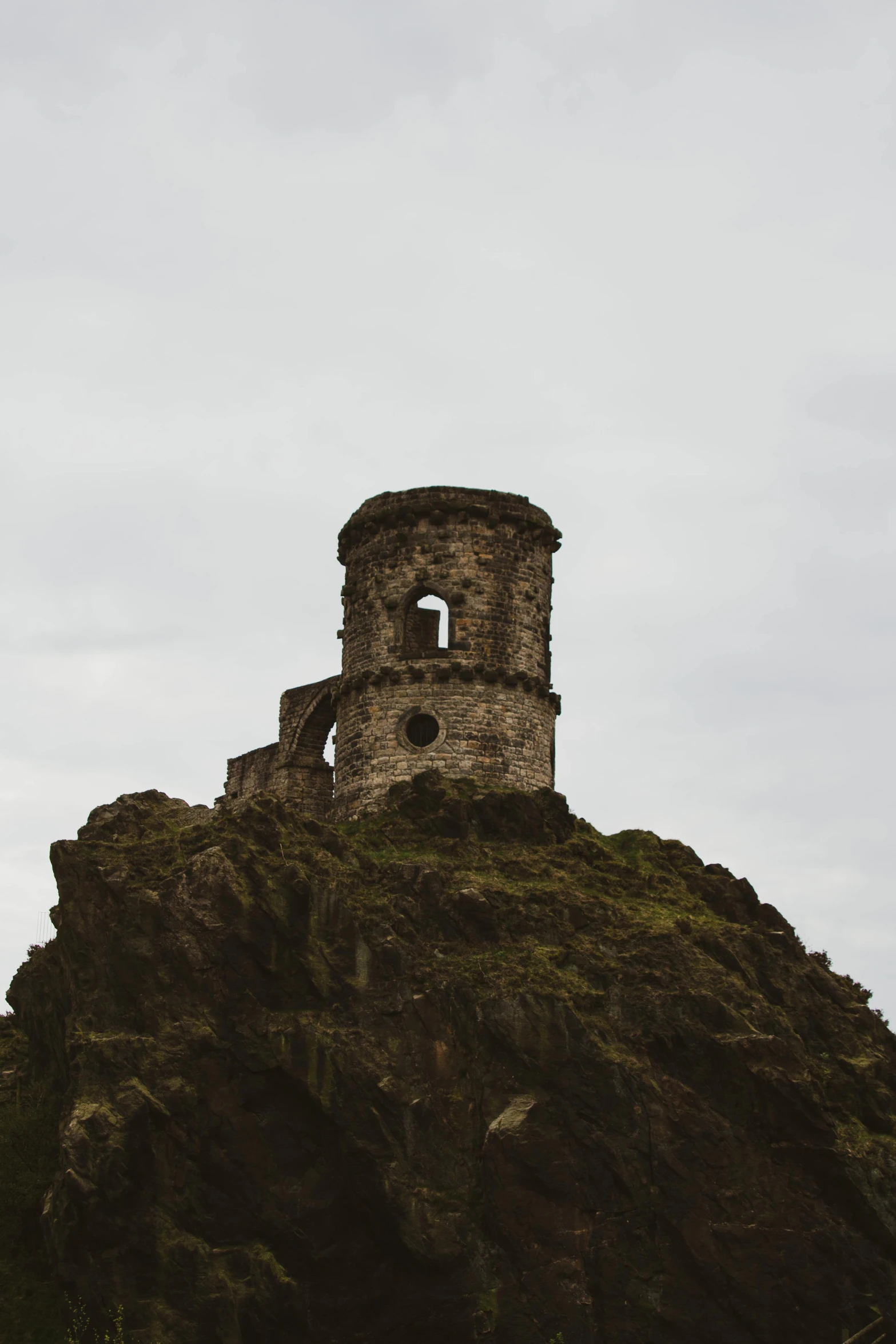 an old brick building on top of a steeple