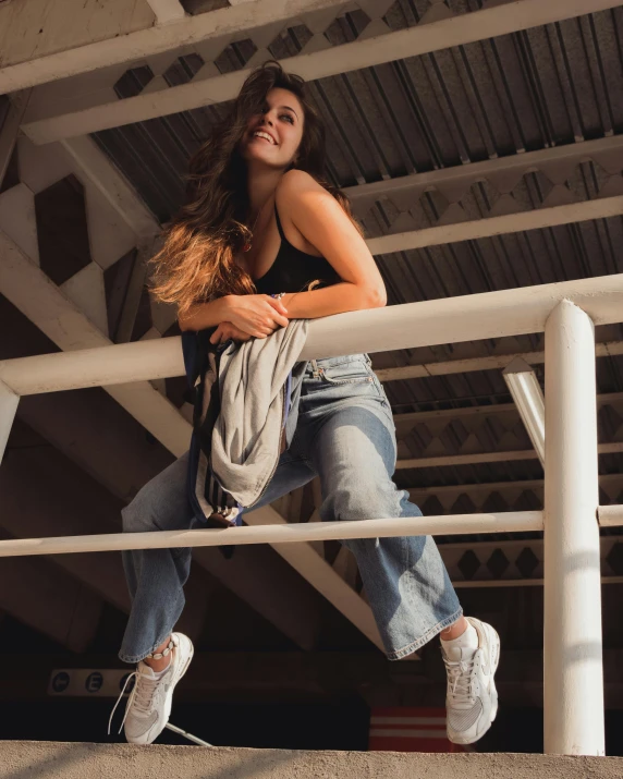 a woman leans on the rail while leaning on a railing