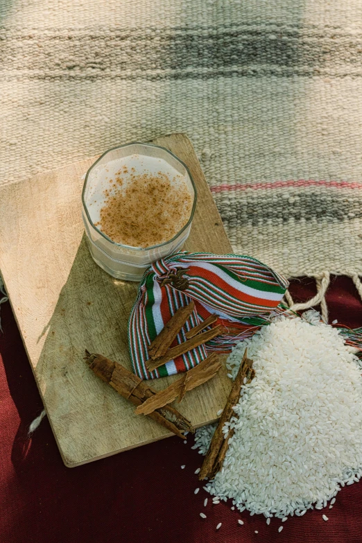 spices, cinnamon sticks and a bowl sit next to some flour