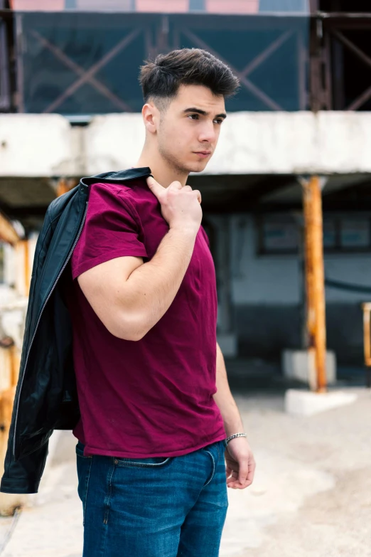 a young man is in a red shirt with a black jacket