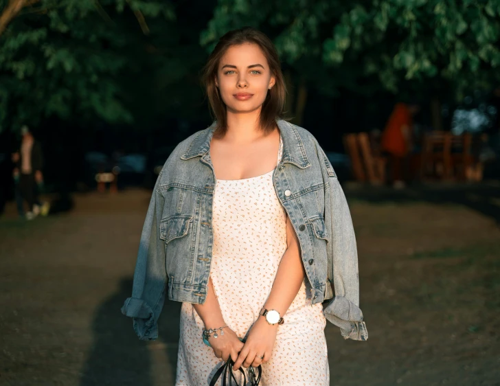 a woman with a handbag is in a park