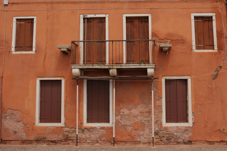 an orange building with multiple windows and balconies