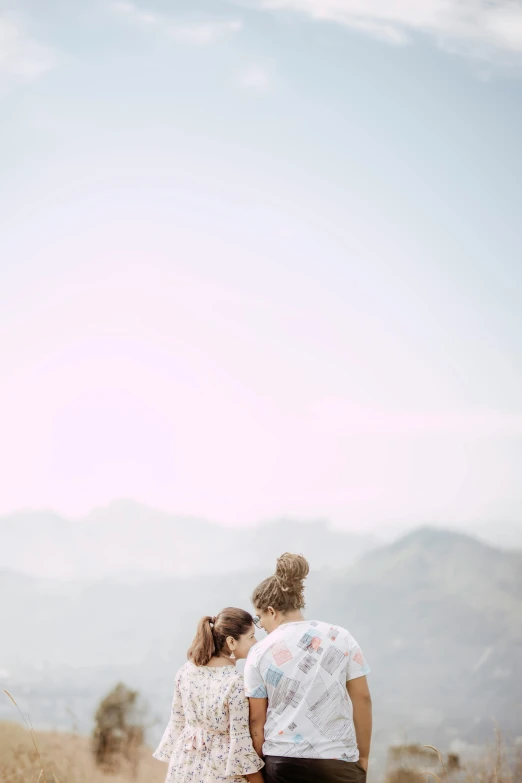 two people in a field on a sunny day